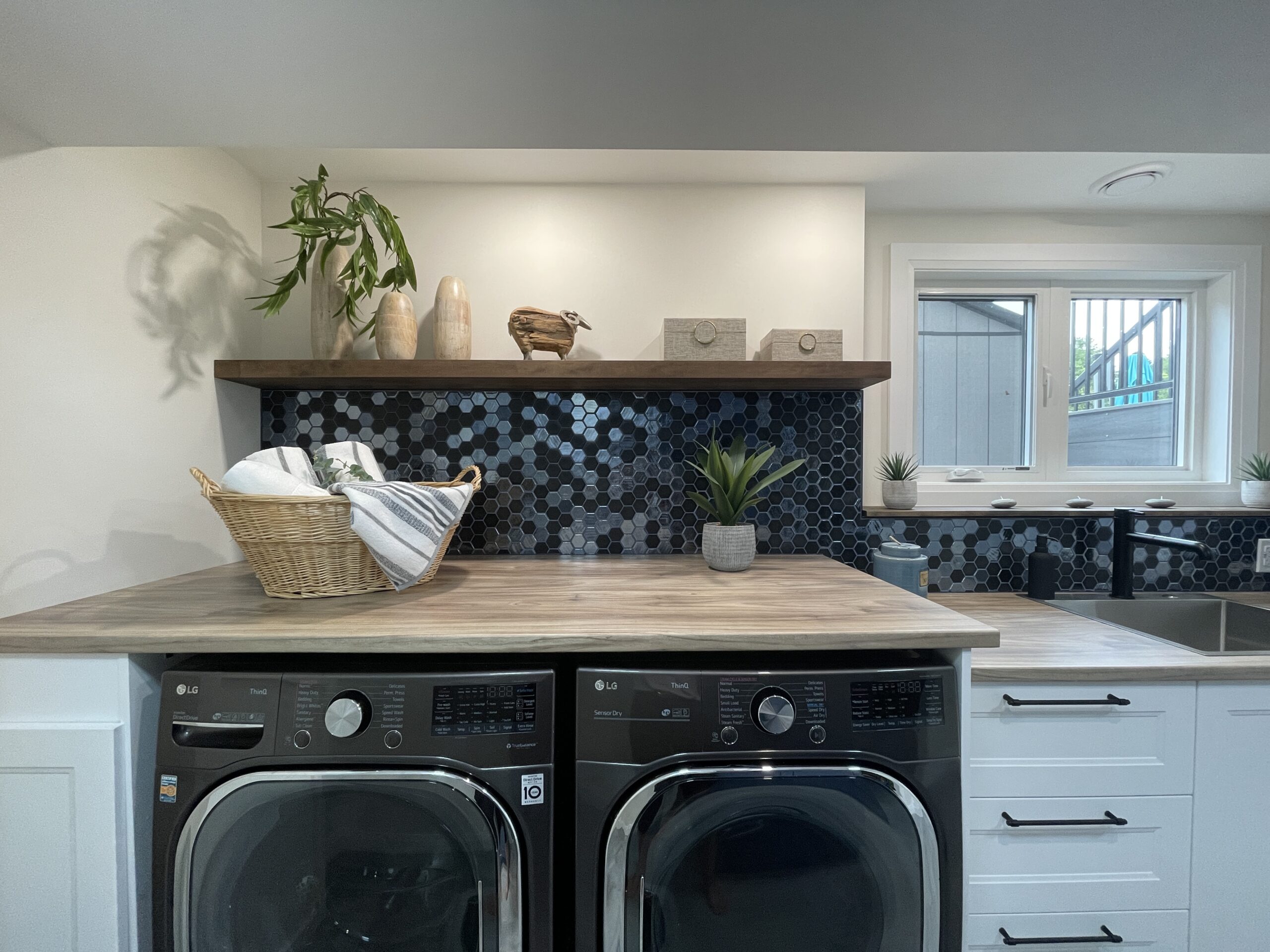 Laundry room folding counter above washer and dryer with decorative styling in Kemptville renovation