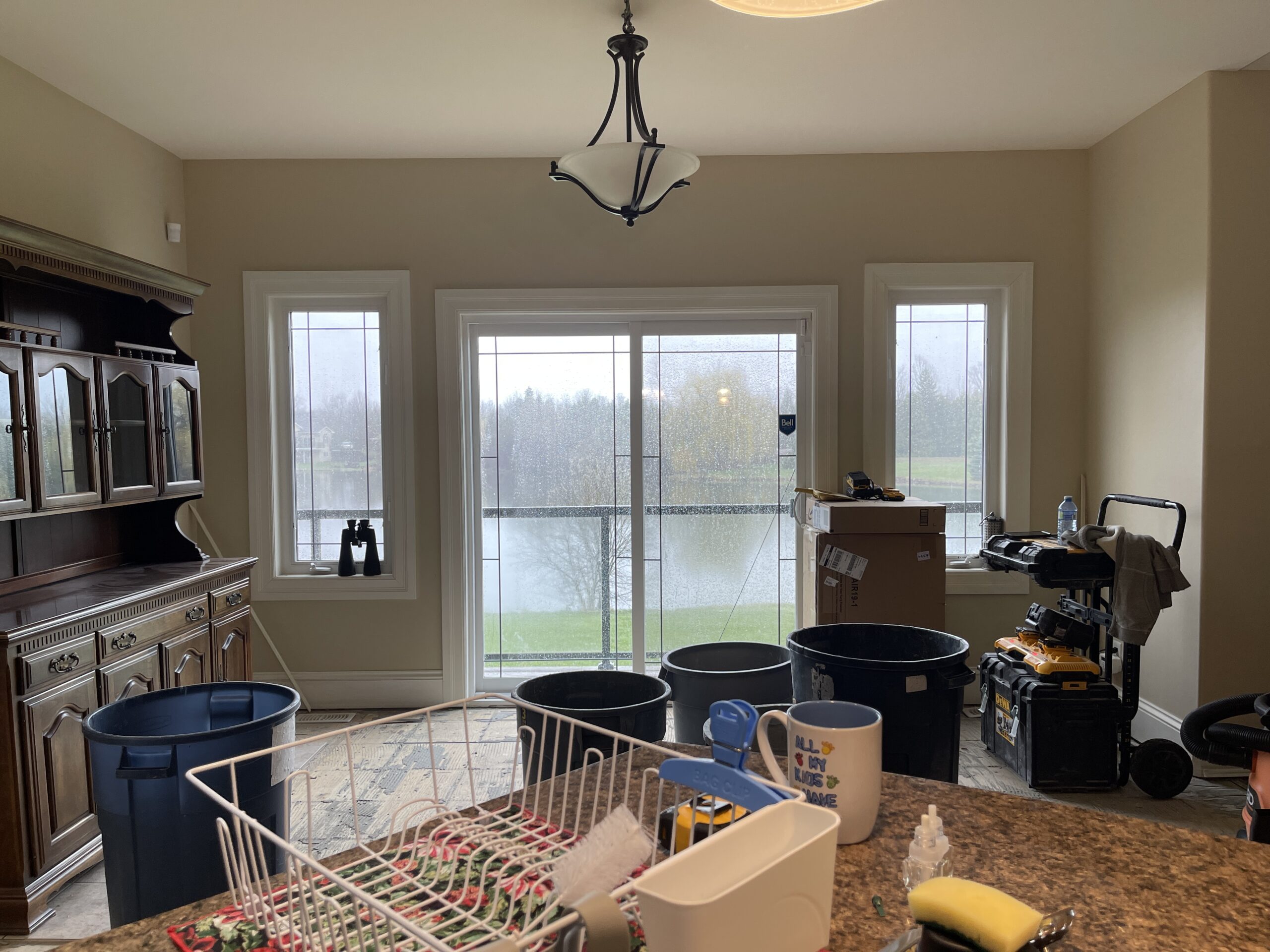 Before kitchen renovation showing original patio door with side windows and breakfast area layout in Carleton Place home