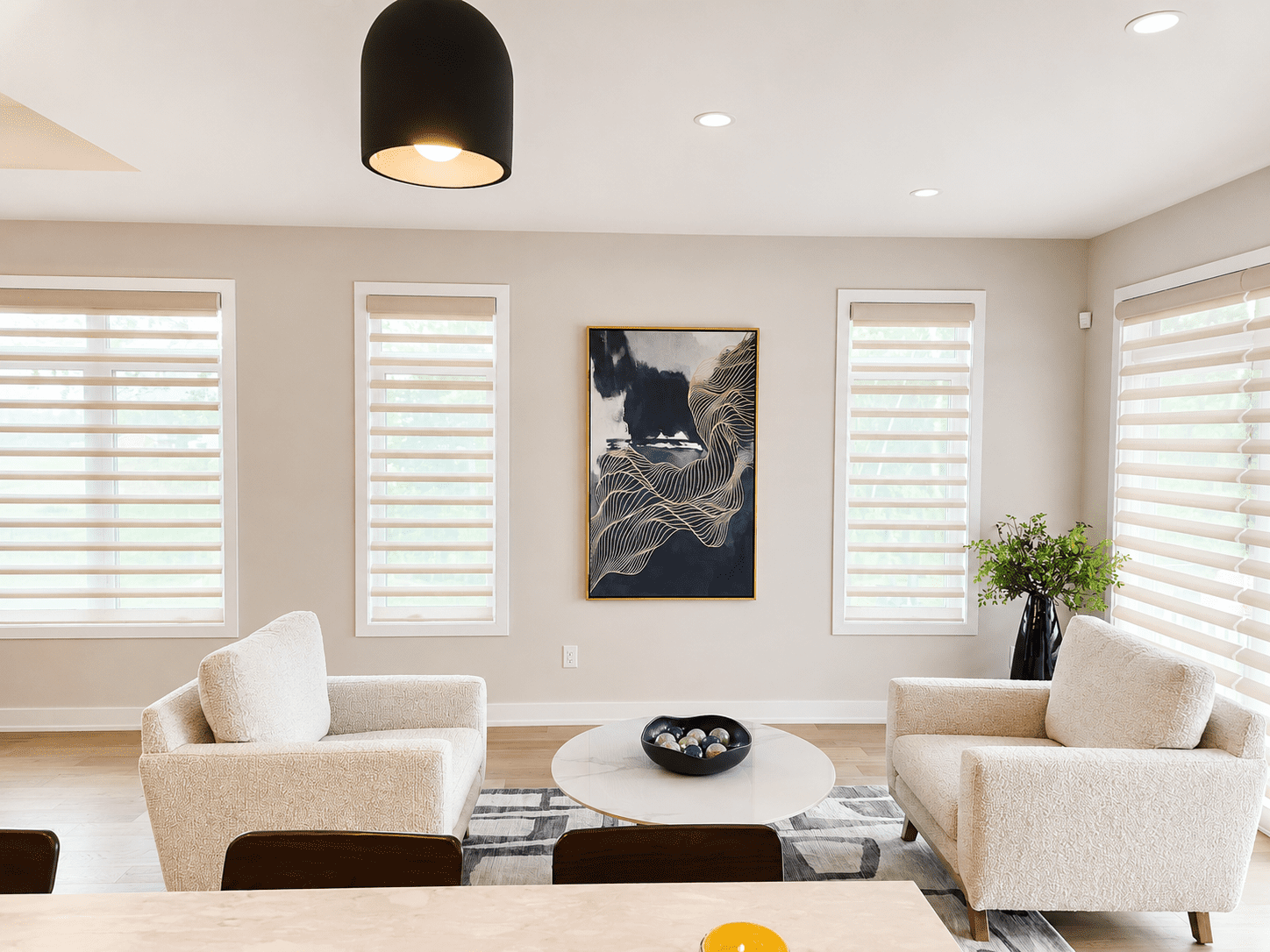 Contemporary sitting area with neutral accent chairs, artwork, and minimalist styling in Hallville Ontario home.