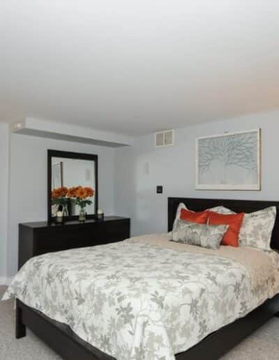 Staged bedroom in white and orange by Cindy Lutes, Total Home