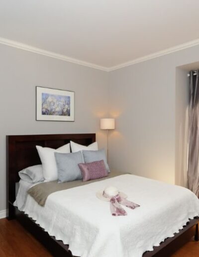 Staged Bedroom in purple and grey by Cindy Lutes, Total Home.