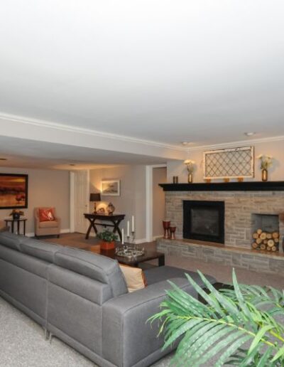 Staged basement in orange and grey by Cindy Lutes, Total Home