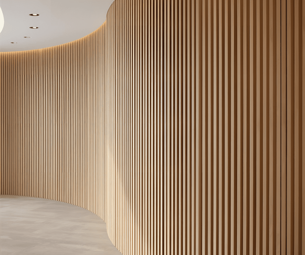 Curved wall finished with vertical fluted slat panels, a modern alternative to traditional wainscot trim detail.