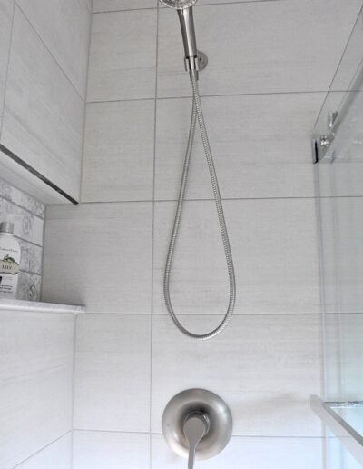 Modern tile shower wall with rainfall shower-head in renovated Kemptville family bathroom