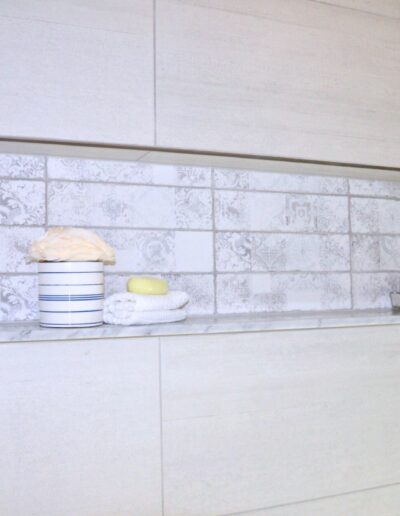 Tile niche with toiletries in modern Kemptville family bathroom renovation