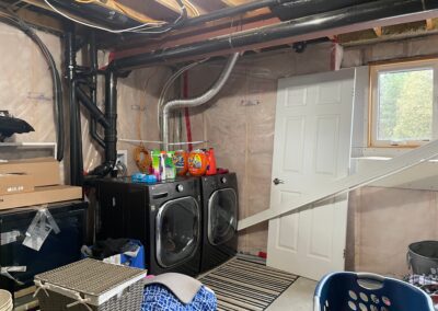 Basement washer and dryer area before renovation with exposed utilities in Kemptville laundry room