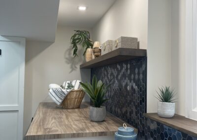 Wraparound laundry folding counter with floating shelf in Kemptville custom laundry renovation