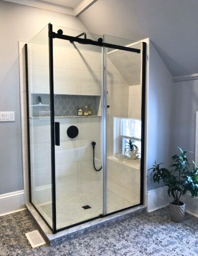 Frameless glass shower enclosure with black hardware in Kemptville bathroom renovation