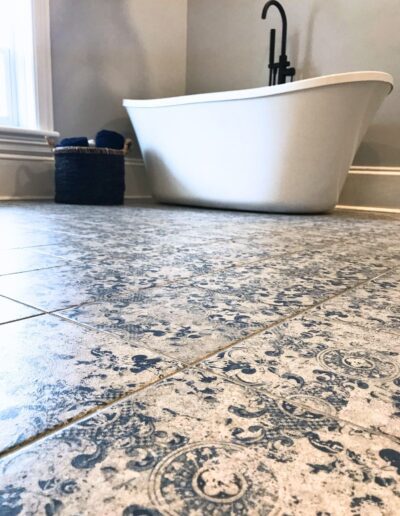 Patterned bathroom floor tile beside freestanding tub in Kemptville renovation