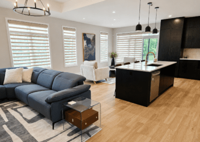 Open-concept living room with navy sectional and curated furnishings following interior design consultation.